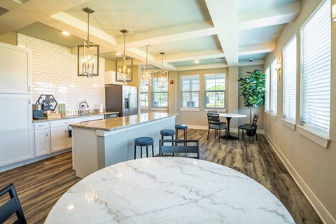 a kitchen and dining room with a large marble table