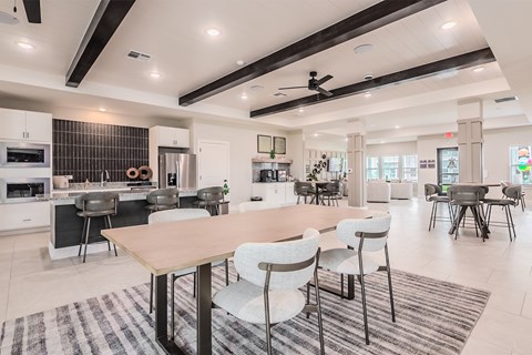 A modern kitchen with a dining table and chairs.