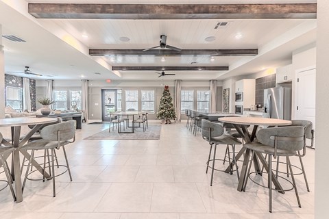 A modern dining room with a Christmas tree in the middle.