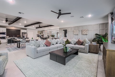 A modern living room with a grey sofa set and a black coffee table.