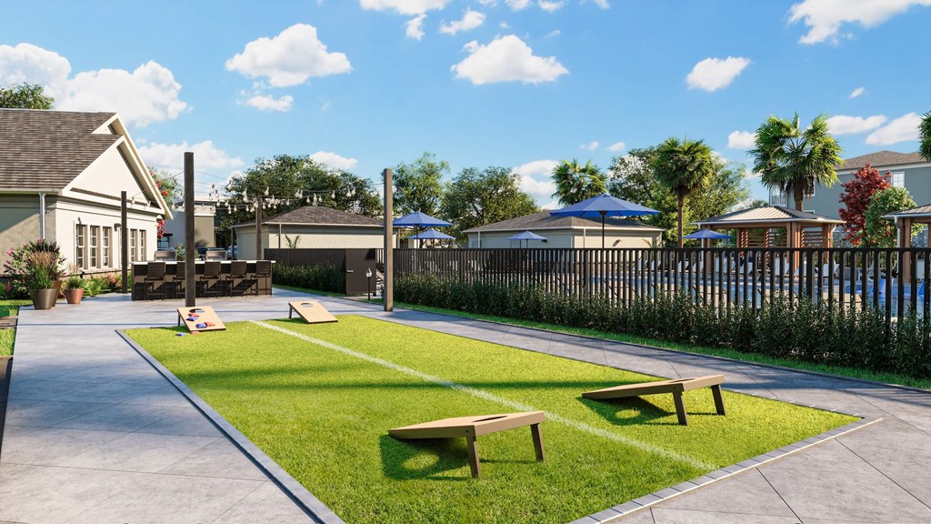 Rendering of a grass area with cornhole boards at Vanguard apartments
