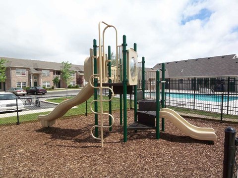 a playground with two slides at canterbury house apartments in warsaw indiana
