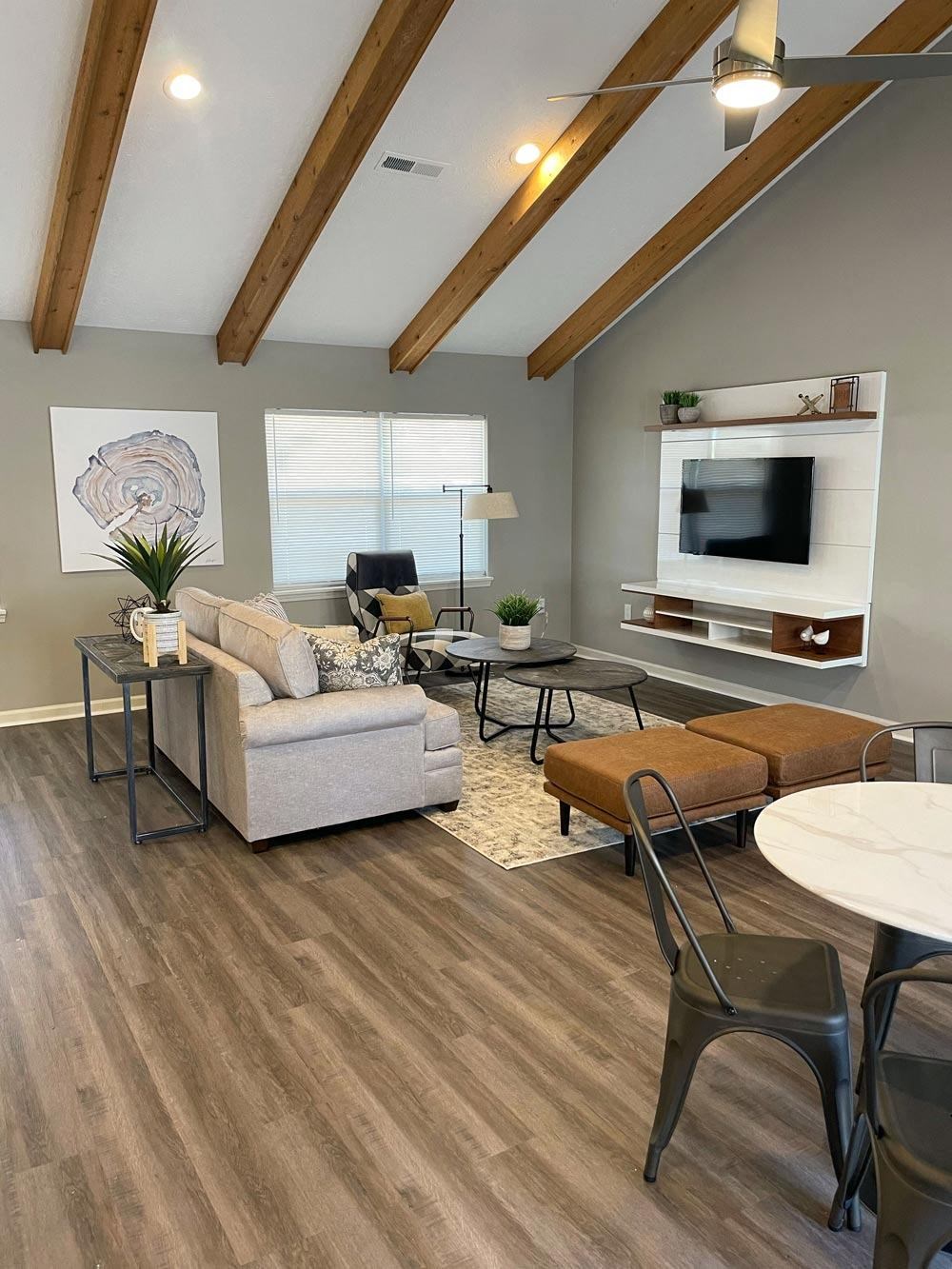 Clubhouse lounge area with couch and table at Canterbury House Apartments in Columbus Indiana