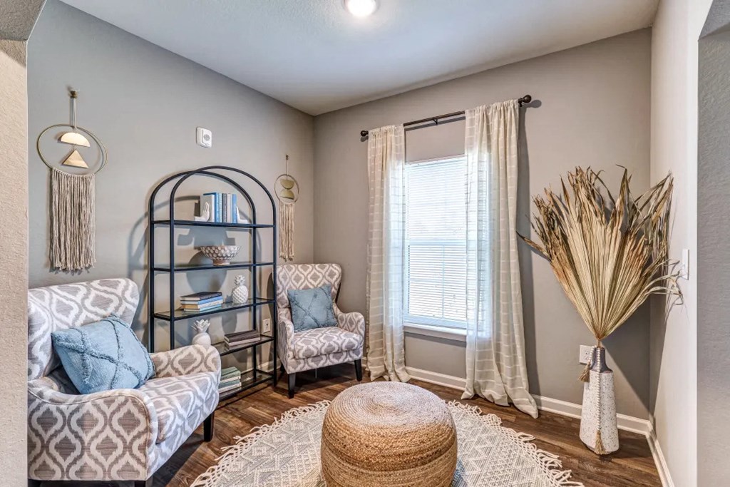 Small room with two chairs a table and window at Flats at Sundown apartments in North Port, Fl