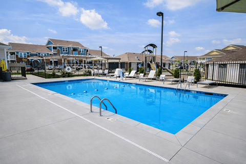 A large swimming pool with a blue tinted water.