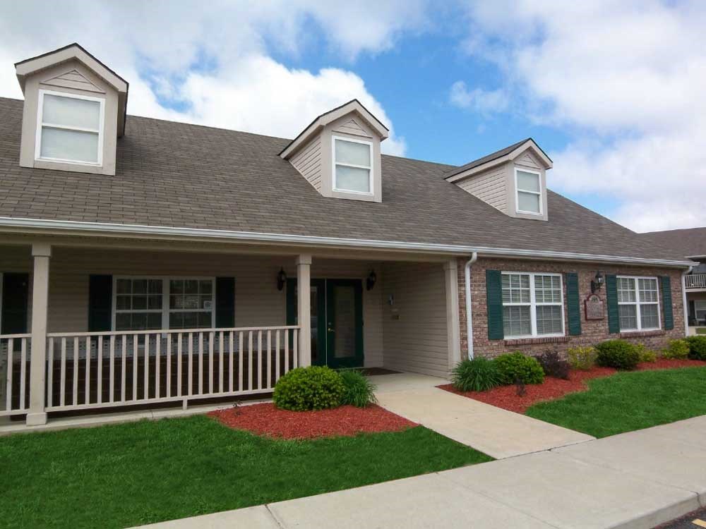 Clubhouse with a covered front porch at Canterbury House apartments in Warsaw, IN