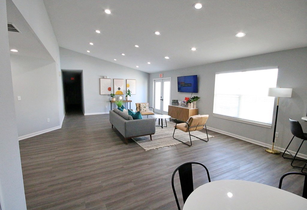 Clubhouse lounge area with a grey couch and a white table at Cobalt apartments in kokomo