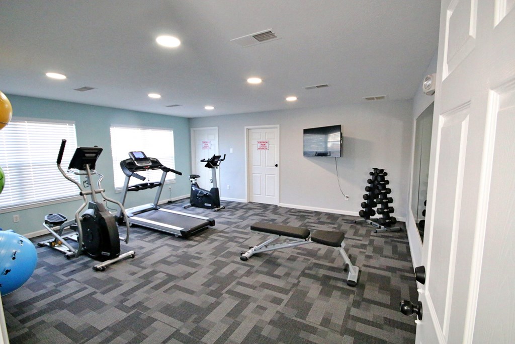 A spacious gym with a variety of exercise equipment at Cobalt Apartments in Kokomo