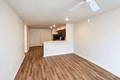 A room with wooden floors and a ceiling fan.
