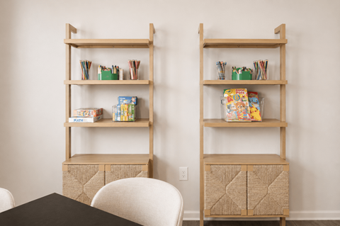 Two shelves with books and boxes on them.