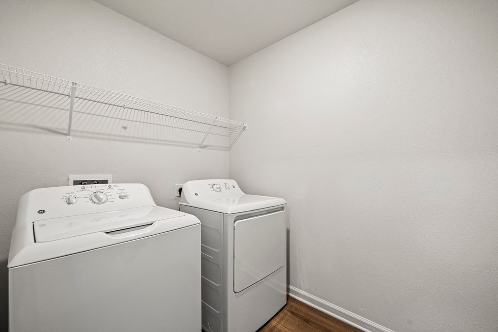 laundry room with a washer and dryer at legacy square senior apartments in san marcos tx