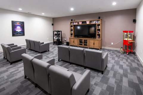 A living room with grey couches and a television.