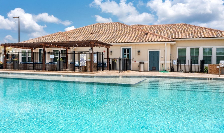The pool and exterior clubhouse at the Flats at Sundown in North Port, Florida