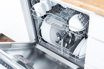 A dishwasher is full of clean dishes.