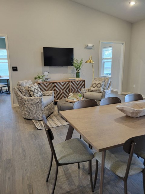 a living room with a table and chairs at Southern Meadows apartments