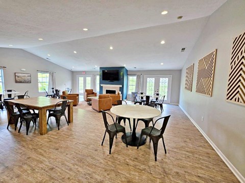 A spacious room with a fireplace and a television.