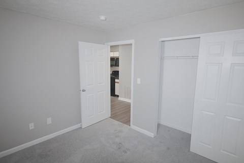 A room with a carpeted floor and white walls.