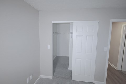 A white door is in the middle of a room.