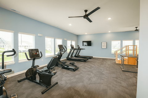 A spacious gym with a variety of exercise equipment.