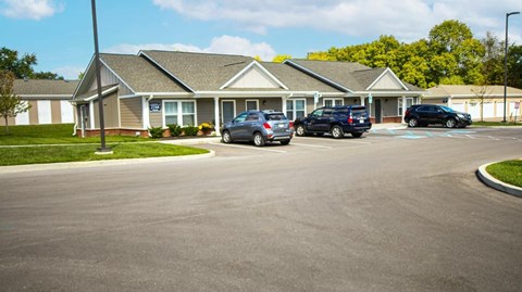 A building with a parking lot in front of it.