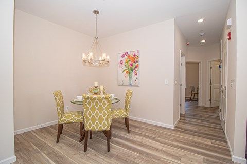 A dining room with a table set for four.