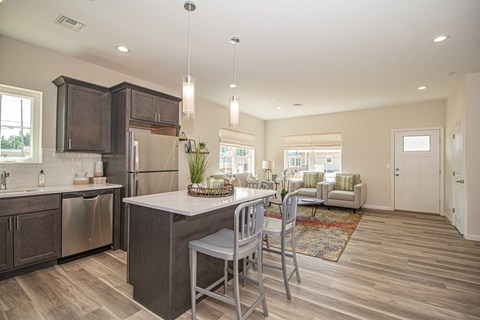 A modern kitchen with a dining table and chairs.