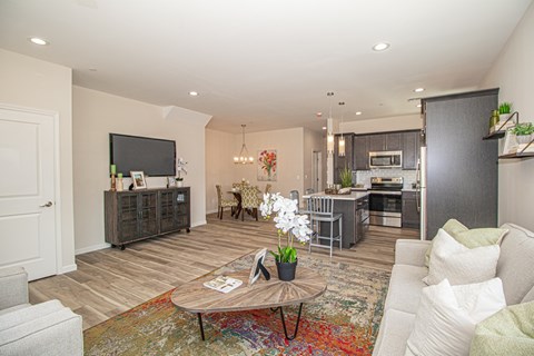 A living room with a white couch and a coffee table.
