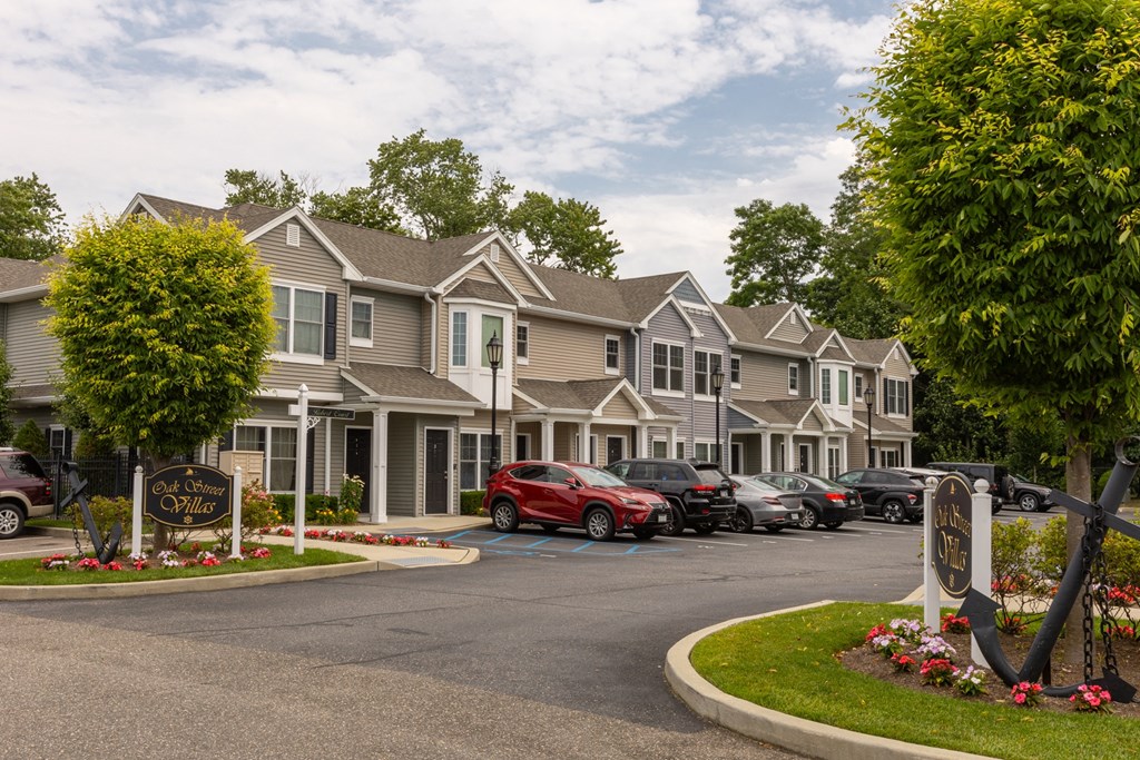a row of houses with cars parked in front of them