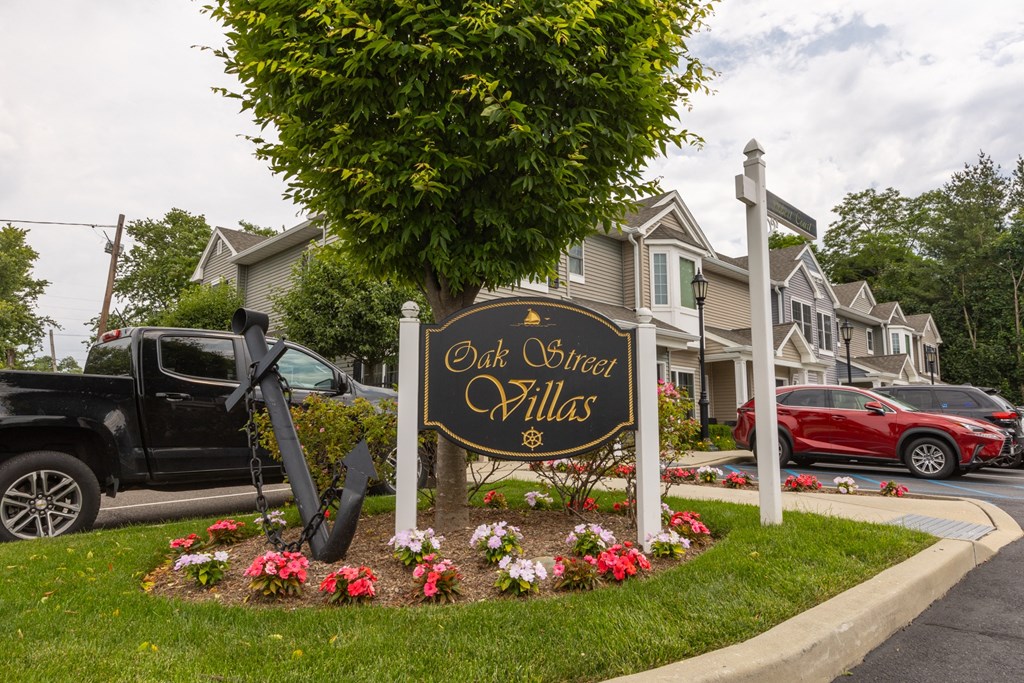 a sign for old oliver hills in front of a row of houses