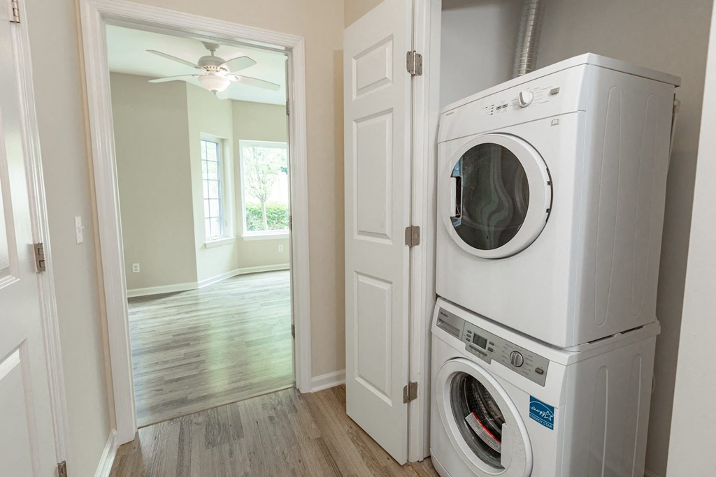 a white washer and dryer in a white laundry room
