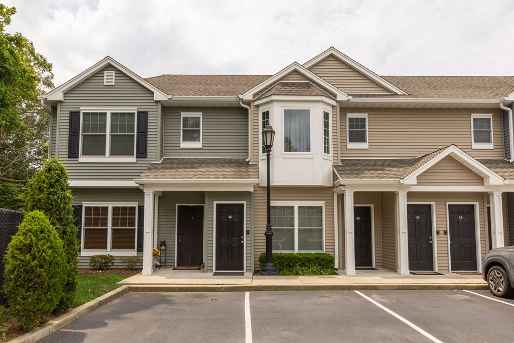 a house with a parking lot in front of it