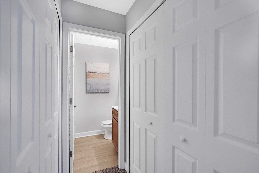a bathroom with a toilet and a sink at Stonewater Apartments, Louisville