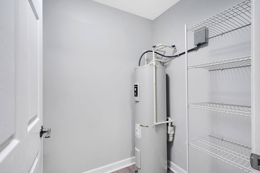 a small water heater in the corner of a room next to a door at Stonewater Apartments, Louisville Kentucky