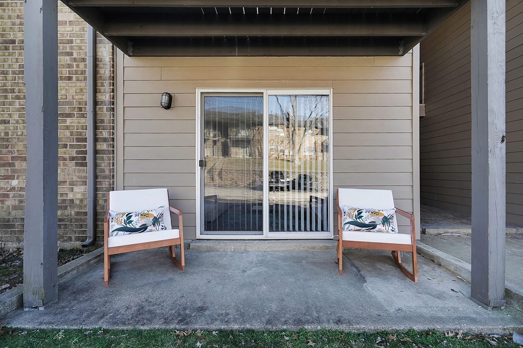two chairs sit on a patio in front of a door at Stonewater Apartments, Louisville, KY 40241