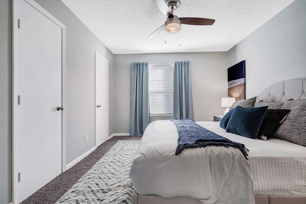 a bedroom with a large bed and a ceiling fan at Enclave at Breckenridge Apartments, Louisville, Kentucky