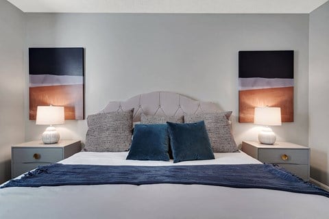 a bedroom with a bed and two night stands with lamps at Enclave at Breckenridge Apartments, Kentucky, 40220