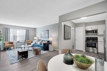 a living room with a couch and a table with a vase on top of it at Enclave at Breckenridge Apartments, Louisville, KY