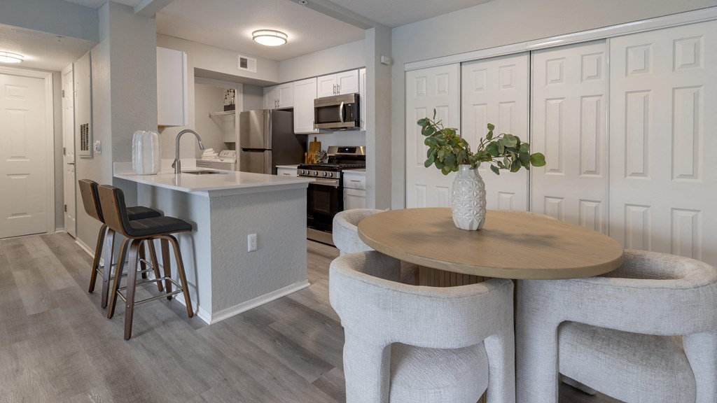 a kitchen and dining area with a table and chairs