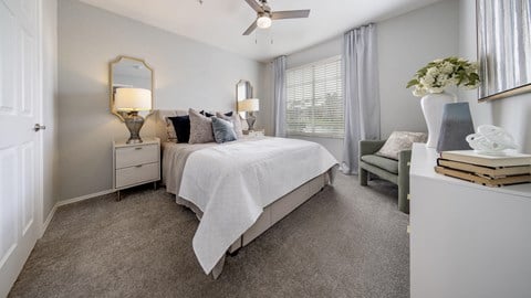 a bedroom with a bed and a ceiling fan