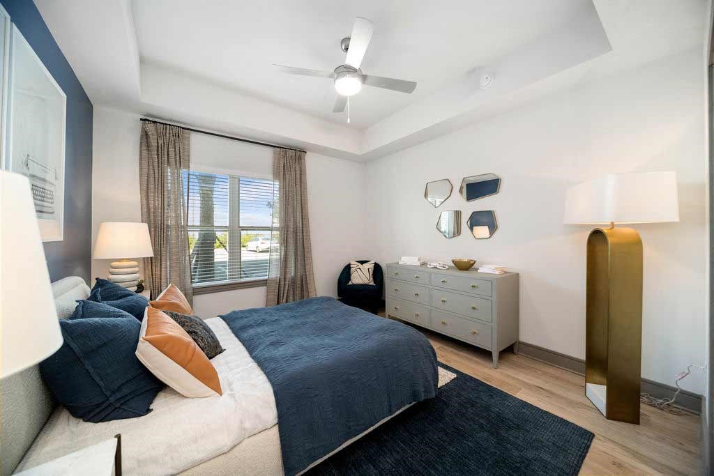 a bedroom with a bed and a ceiling fan