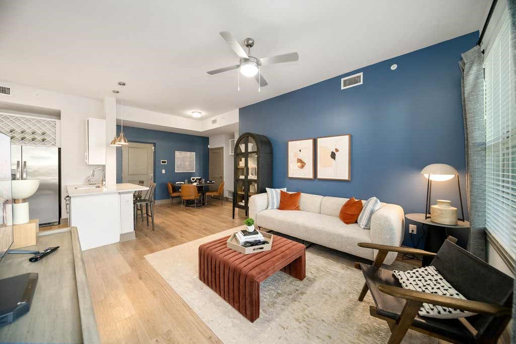 a living room with a blue accent wall and a couch
