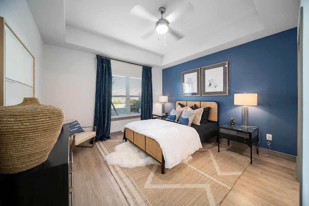 a bedroom with a bed and a ceiling fan