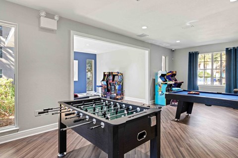 A pool table in a room with a foosball table and a pool table.at Coastline Apartments, Fort Walton Beach, 32547