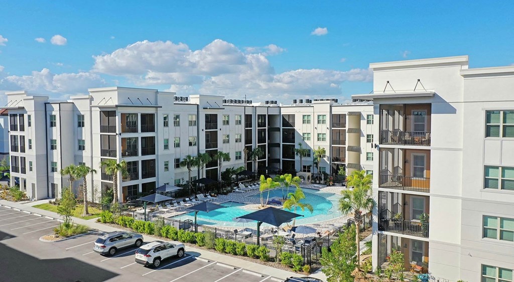 an aerial view of an apartment complex with a swimming pool