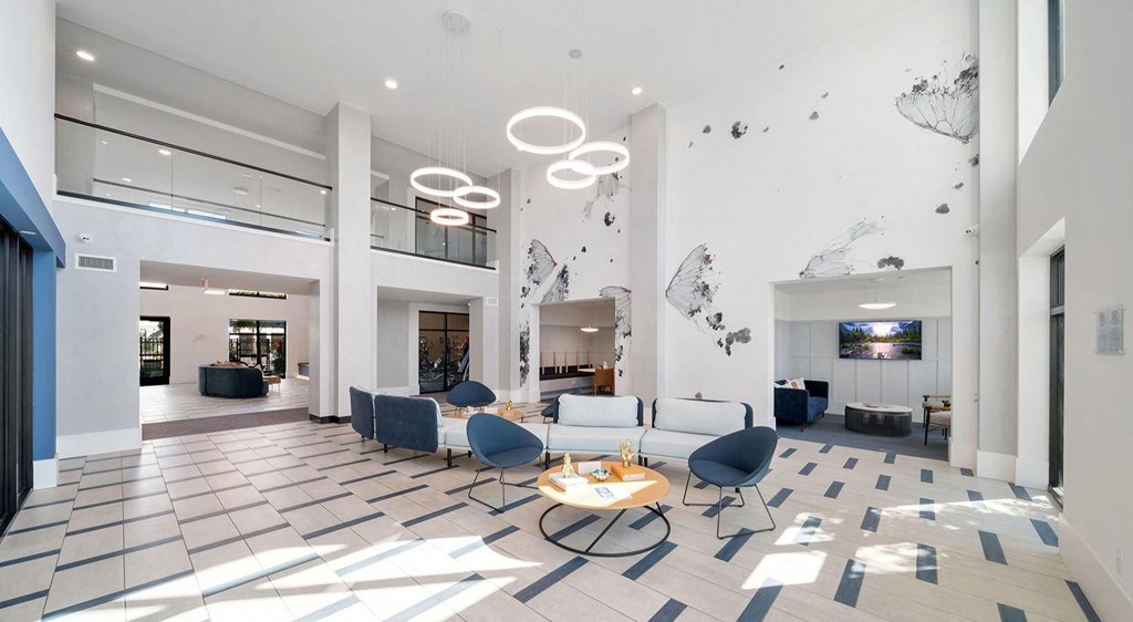 a lobby with couches and chairs and a table