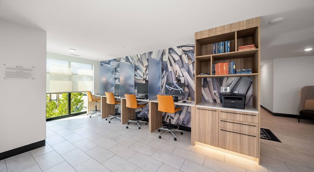 a room with a desk and chairs and a wall mural