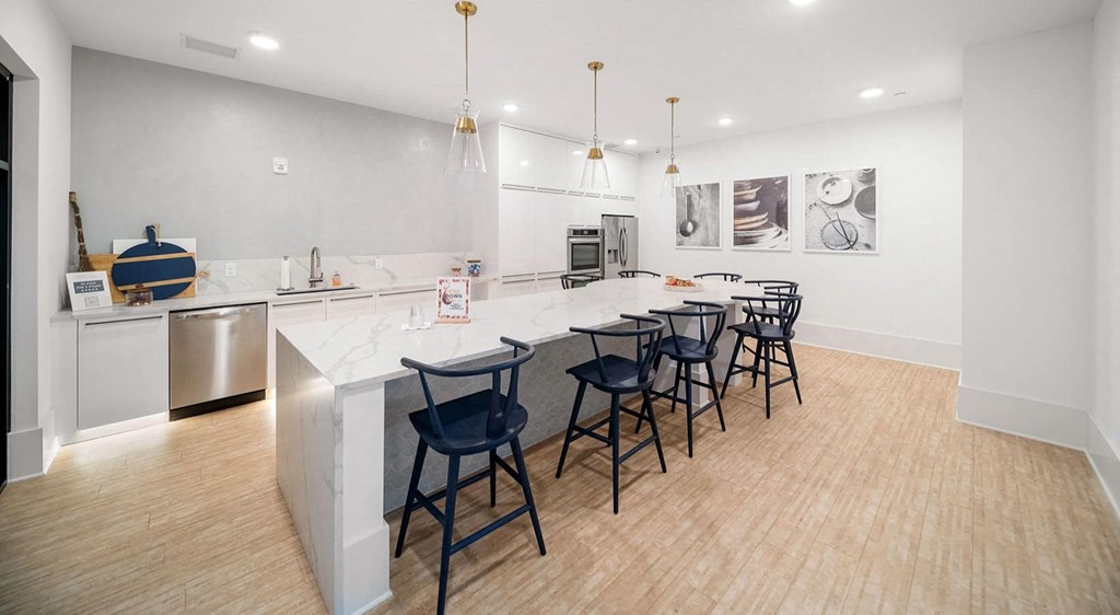 a kitchen with a marble counter top and bar stools