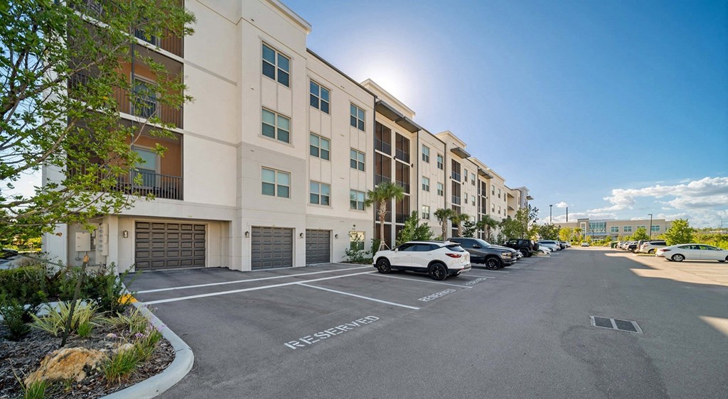 an empty parking lot in front of an apartment building