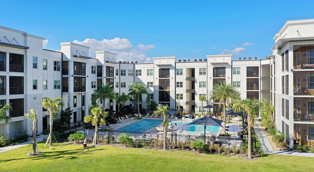a swimming pool in front of The Pearl apartments in Naples FL