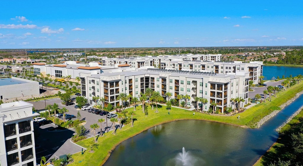 an aerial view of a large building next to a body of water